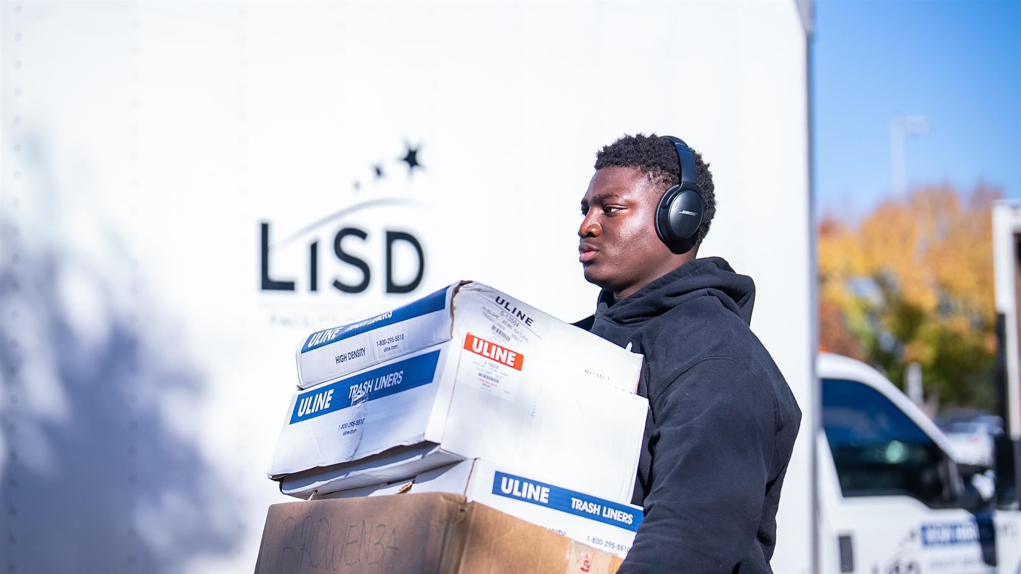 Michael Fasusi loads supplies for the LISD Angel Tree program onto a truck